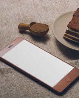 Free Smartphone And A Tasty Cake On A Table