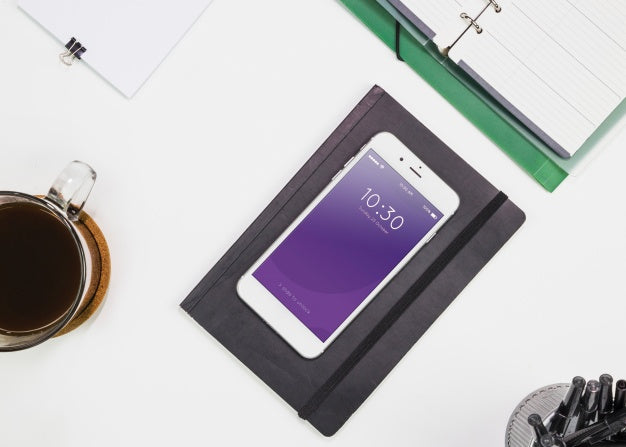 Free Smartphone Mockup With Office Materials On Table Psd