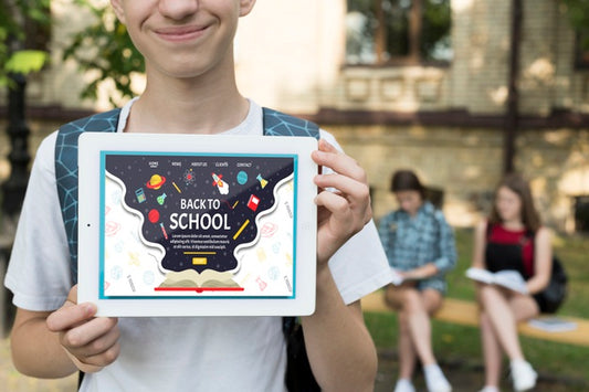 Free Smiley Boy Holding A Tablet Mock-Up Psd