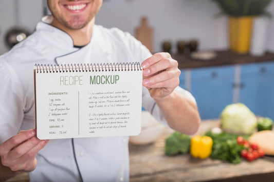Free Smiley Chef Holding A Recipe Mock-Up Psd