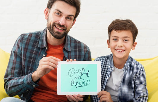 Free Smiley Father And Son Holding Electronic Tablet Psd