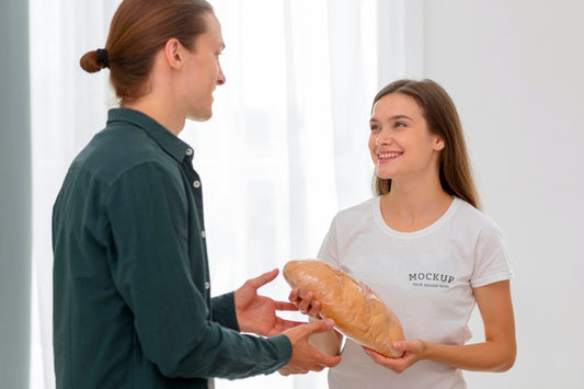 Free Smiley Female Volunteer Handing Out Bread To Man Psd