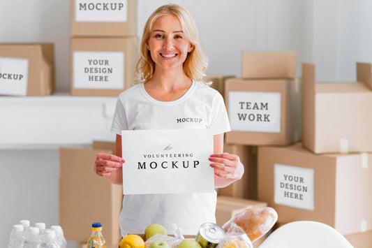 Free Smiley Female Volunteer Holding Blank Paper Next To Food Box Psd