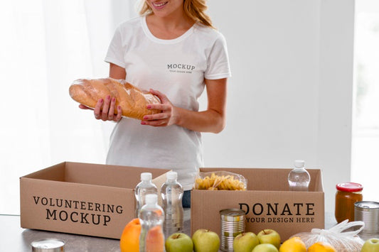Free Smiley Female Volunteer Preparing Food In Box For Donation Psd