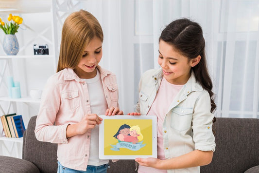 Free Smiley Girls Holding A Tablet Mock-Up Psd