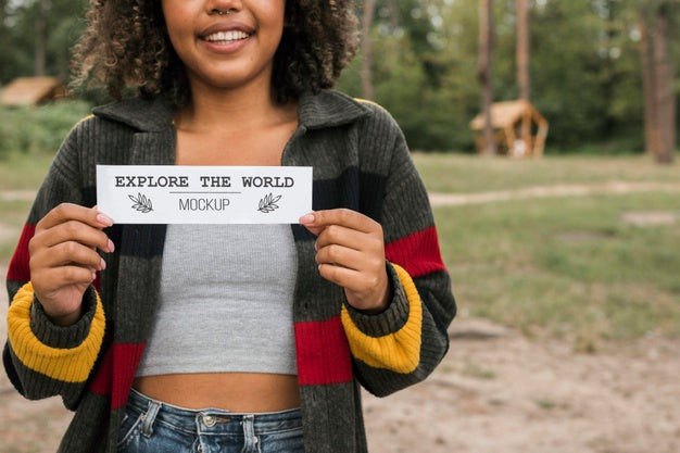 Free Smiley Woman Holding A Piece Of Paper While Camping Psd