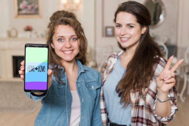 Free Smiling Girls Presenting Smartphone Mockup Psd