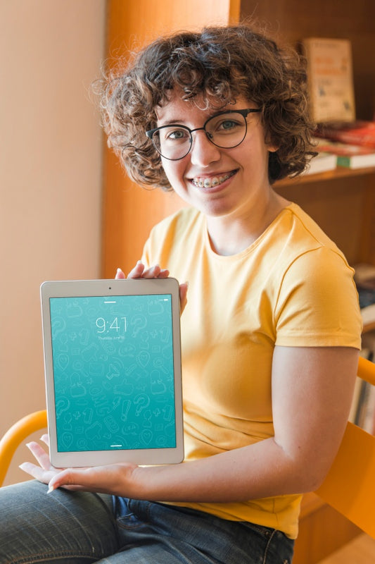 Free Smiling Woman Holding Tablet Mockup In Library Psd