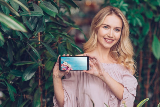 Free Spring Concept With Woman Holding Smartphone Mockup Psd