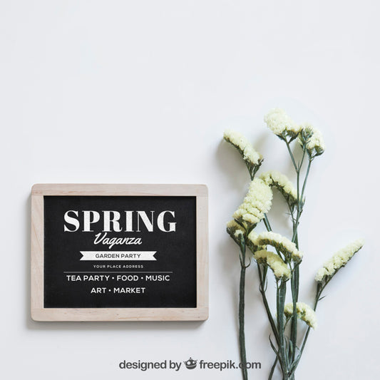 Free Spring Mockup With Slate Next To White Flowers Psd