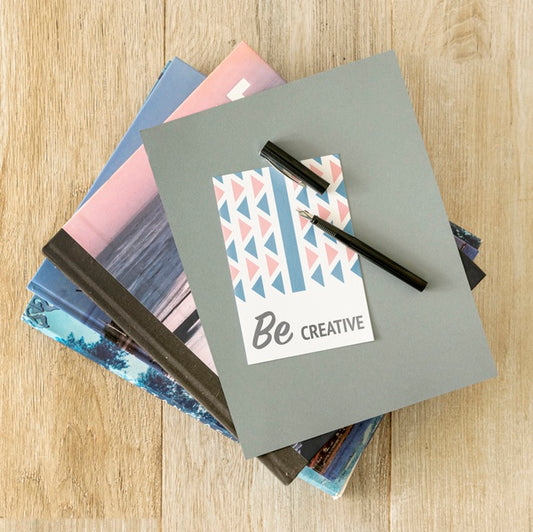 Free Stack Of Agenda On Desk With Pen On Top Psd