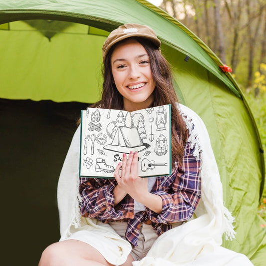Free Summer Camp Mockup With Woman Showing Open Book Psd