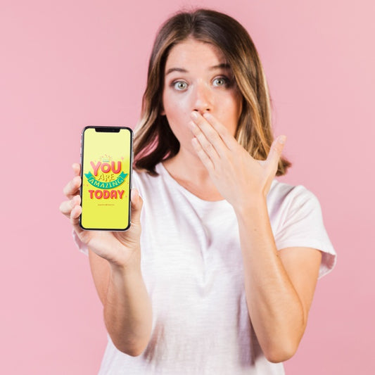 Free Surprised Young Woman Covering Her Mouth And Holding A Cellphone Mock-Up Psd
