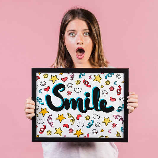 Free Surprised Young Woman Showing A Frame Mock-Up Psd
