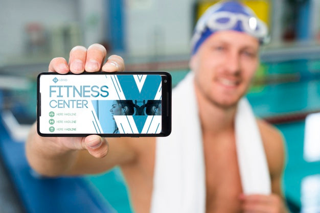 Free Swimmer Holding A Mobile Phone With Fitness Center Landing Page Psd