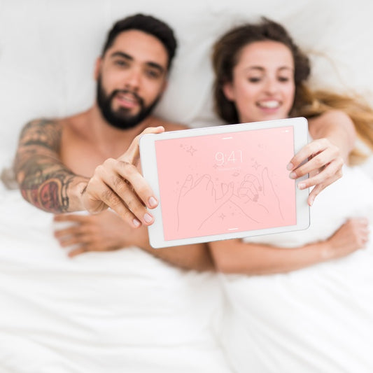 Free Tablet Mockup With Couple In Bed Psd
