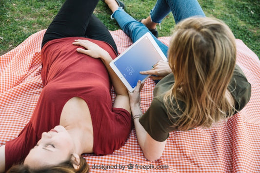 Free Tablet Mockup With Women Having A Picnic Psd