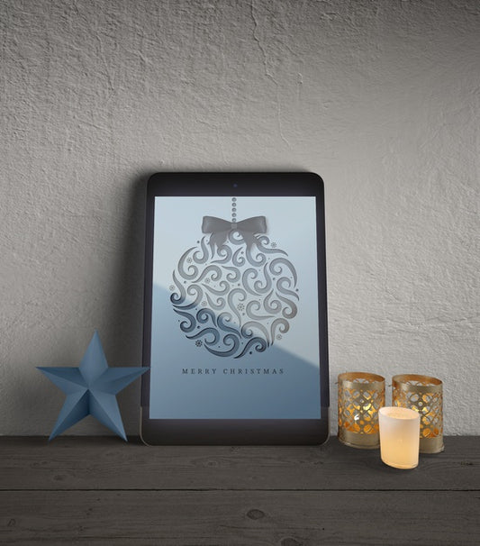Free Tablet With Christmas Decorations Beside Psd
