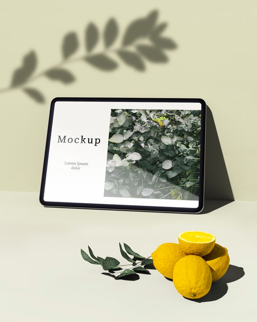 Free Tablet With Citrus And Leaves Psd