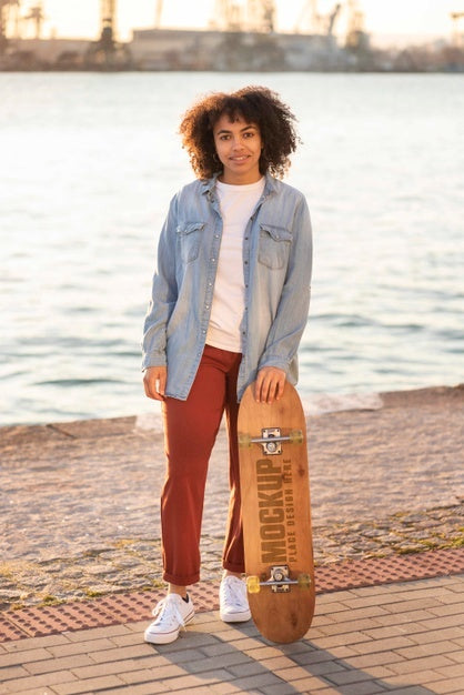 Free Teenager With Mock-Up Skateboard At The Pier Psd