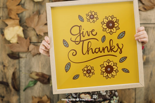 Free Thanksgiving Mockup With Kid Holding Frame Psd