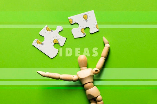 Free Top View Arrangement With Puzzle Pieces And Wooden Robot Psd