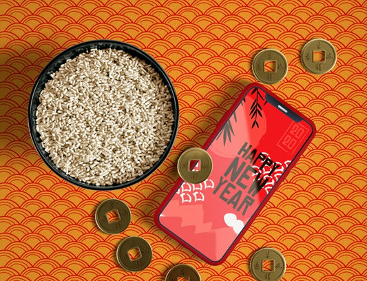 Free Top View Bowl Of Rice Golden Coins And Phone Mock-Up Psd