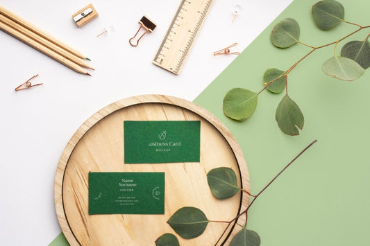 Free Top View Business Cards On Wood With Plant Psd