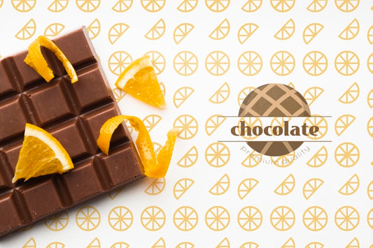 Free Top View Chocolate With Orange Background Mock-Up Psd