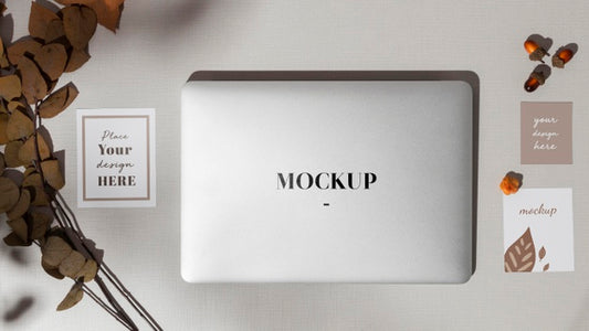 Free Top View Closed Laptop With Mockup With Leaves Psd