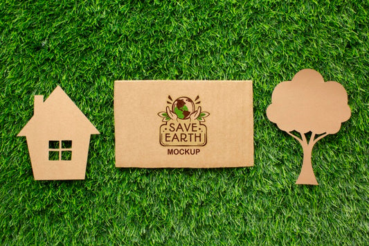 Free Top View Eco Cardboard Mock-Up With Paper House And Tree Psd