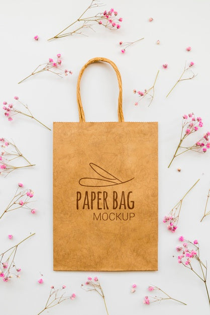 Free Top View Flowers And Paper Bag Arrangement Psd