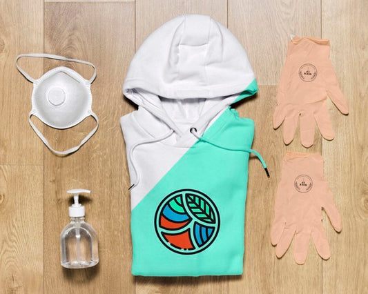 Free Top View Folded Hoodie Mock-Up With Gloves And Hand Sanitizer Psd
