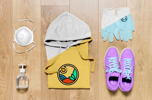 Free Top View Folded Hoodie Mock-Up With Hand Sanitizer, Mask And Gloves Psd