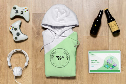 Free Top View Green Folded Hoodie Mock-Up With Gadgets And Bottles Psd