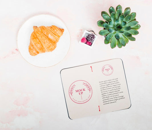 Free Top View House Plant With Croissant On The Table Psd