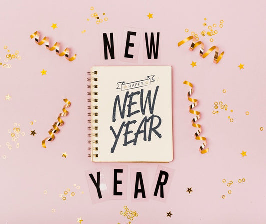 Free Top View New Year Minimalist Lettering On Notepad Psd
