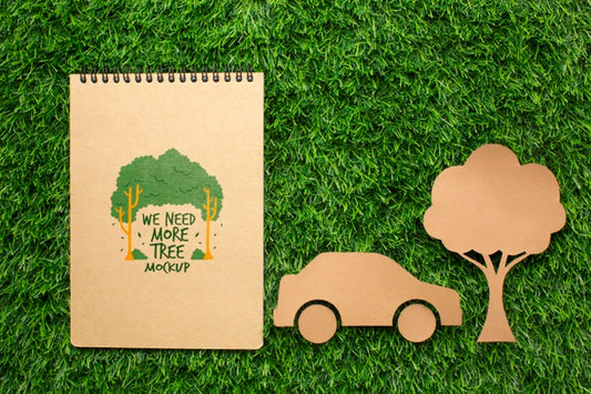 Free Top View Notebook Mock-Up And Paper Car And Tree Psd
