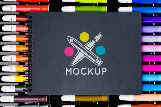 Free Top View Notebook On Colorful Markers Psd