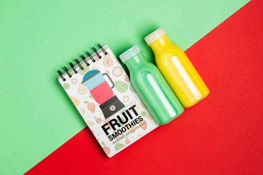 Free Top View Notepad And Bottles With Fruit Smoothie Psd