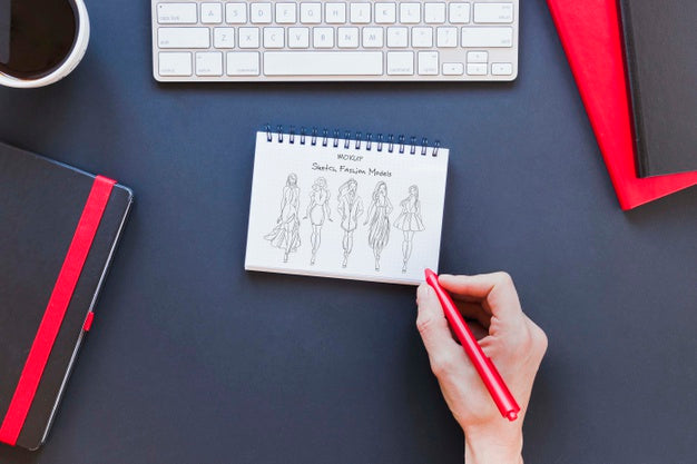 Free Top View Notepad With Drawing On The Desk Psd