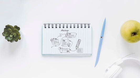 Free Top View Notepad With Drawing On The Desk Psd