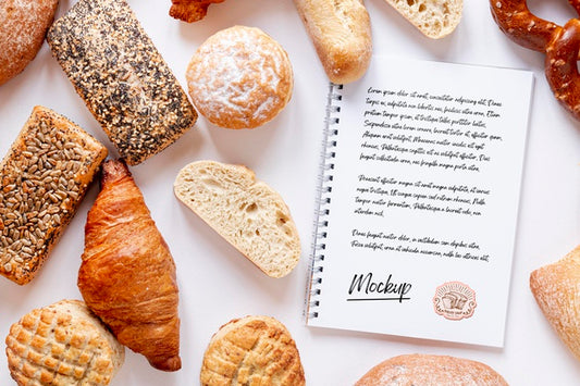 Free Top View Of Assortment Of Bread With Notebook Psd