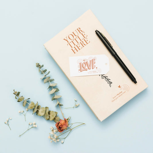 Free Top View Of Book Mock-Up With Pen And Flowers Psd