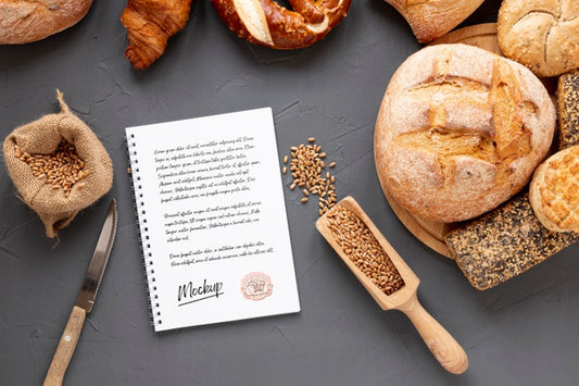 Free Top View Of Bread With Wheat And Notebook Psd