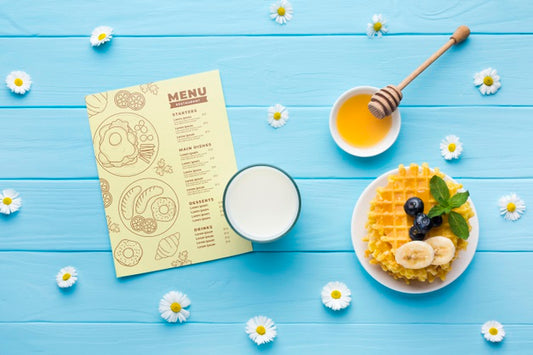 Free Top View Of Breakfast Food With Waffles And Milk Psd