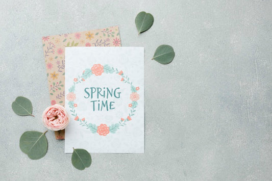 Free Top View Of Card With Leaves And Spring Rose Psd