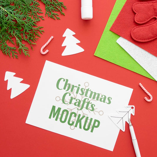 Free Top View Of Christmas Crafts With Paper And Branch Psd