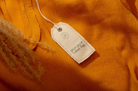Free Top View Of Clothing Label On Orange Textile Psd