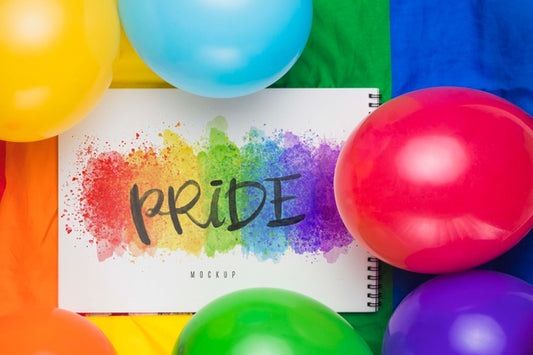 Free Top View Of Colorful Balloons With Rainbow And Notebook Psd